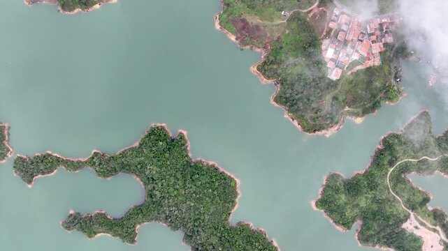 El Pe&ntilde;&oacute;n de Guatap&eacute; Rising Above Guatap&eacute; Reservoir in Antioquia, Colombia. Establishing Shot. Aerial View.