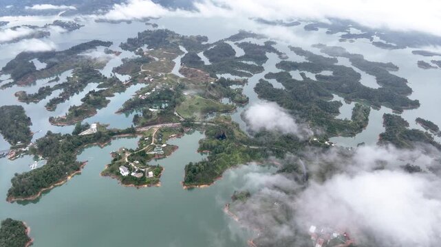 El Pe&ntilde;&oacute;n de Guatap&eacute; Rising Above Guatap&eacute; Reservoir in Antioquia, Colombia. Establishing Shot. Aerial View.