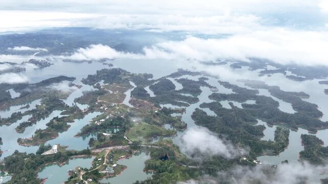 El Pe&ntilde;&oacute;n de Guatap&eacute; Rising Above Guatap&eacute; Reservoir in Antioquia, Colombia. Establishing Shot. Aerial View.