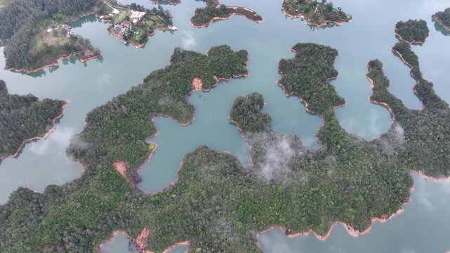 Scenic Guatap&eacute; Lake and Green Islands Surrounded by Mountains in Antioquia, Colombia. Establishing Shot. Aerial View.