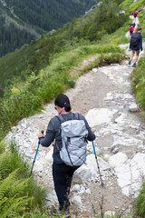 Woman hiking on stony mountain trail © Jorens