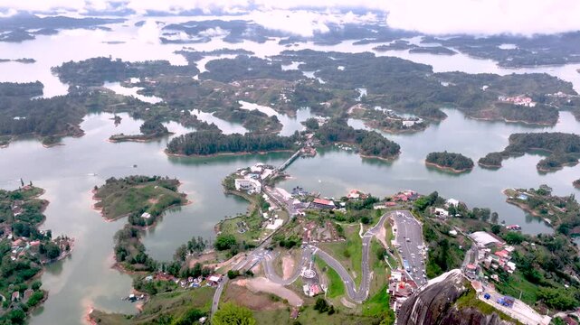 Aerial Panorama of Guatap&eacute; Reservoir and El Pe&ntilde;&oacute;n Surrounded by Islands and Mountains in Colombia. Establishing Shot.