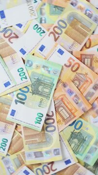 Euro banknote background rotates through visible 50, 100, and 200 euro denominations, offering colorful currency imagery for financial services, business, trade, and payment themes