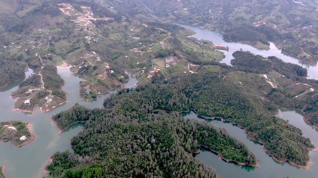 Aerial Panorama of Guatap&eacute; Reservoir and El Pe&ntilde;&oacute;n Surrounded by Islands and Mountains in Colombia. Establishing Shot.