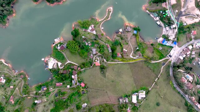 Aerial Panorama of Guatap&eacute; Reservoir and El Pe&ntilde;&oacute;n Surrounded by Islands and Mountains in Colombia. Establishing Shot.