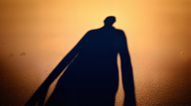 A shot where his shadow on the ground is distorted by the angle of the sun, creating a giant figure behind him.

