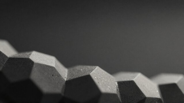close group hexagonal objects objects arranged way overlapping creating sense depth dimension background solid black color making hexagons stand out even more black white giving monochromatic tone