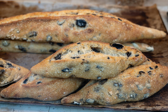 Handcrafted sourdough baguettes made in artisanal bakery in Marais, Paris with long fermentation with cheese, olives and aromatic herbs, and crisp crust