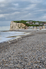 Fototapeta premium Mers-les-Bains, seaside town with 19th-century sea-bathing villas with colorful wooden balconies and white chalk cliffs, tourists destination in France