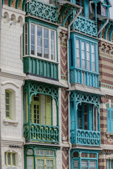 Fototapeta premium Houses of Mers-les-Bains, seaside town with 19th-century sea-bathing villas with colorful wooden balconies and white chalk cliffs, tourists destination in France