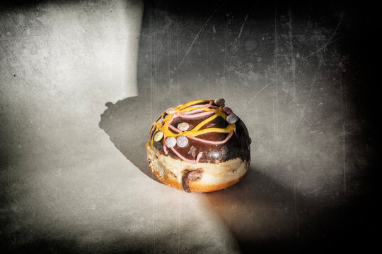 Chocolate donut at the edge of the lighting - vintage photo