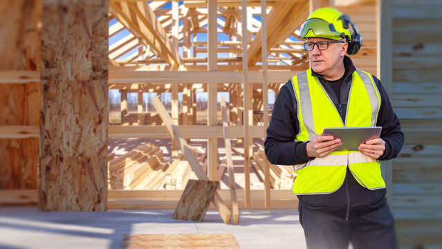 Construction site, building inspector uses a tablet to supervise timber house framing, structural work, safety compliance and contractor operations.