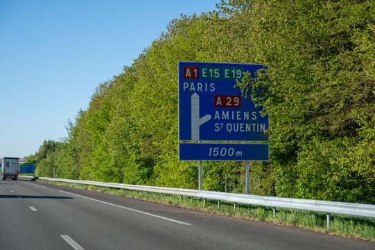 View of a French and European autoroute with overhead directional signs pointing to major cities like Paris, Bordeaux, Lille, Calais, showing lanes, traffic and motorway infrastructure, road signes
