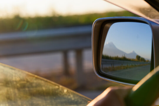 Reflection of Mount Ararat in a car side view mirror while driving a car in Southern Armenia.