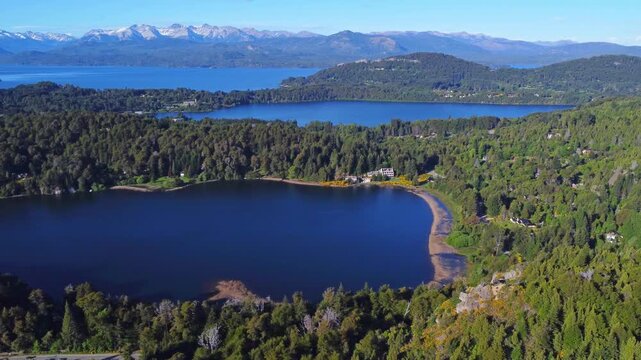 Aerial view of Laguna El Trebol with Nahuel Huapi Lake and the Andes behind, Bariloche, Patagonia Argentina