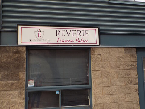 Gloucester, Ontario, Canada &ndash; July 31, 2026: The "Reverie Princess Palace" storefront sign is displayed above a window on a masonry and metal commercial building exterior at 1010 Polytek St Unit 35.