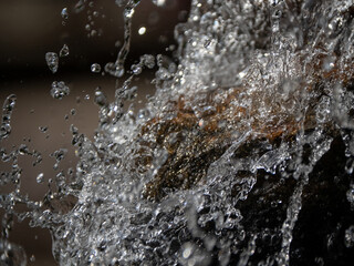 Water Splashing Over Rocks in Close Up Macro Shot © Sergei