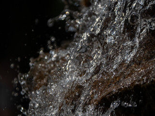 Fresh Water Splashing Over Wet Rock Surface Close Up © Sergei