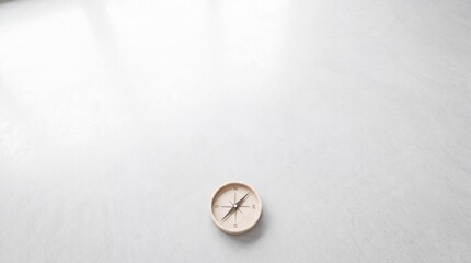 Fototapeta premium Minimalist wooden compass placed on a vast white surface with plenty of copy space for text, symbolizing guidance, strategic direction, core business concepts, navigation, and decision making.