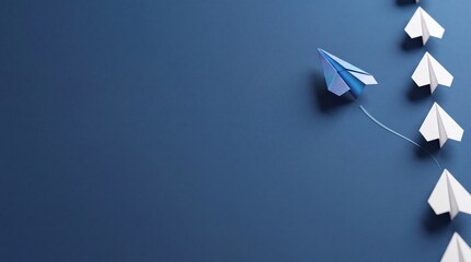 Fototapeta premium A blue paper plane breaking away from a vertical line of white paper planes against a dark blue background with significant negative space on the left, symbolizing leadership and innovation.