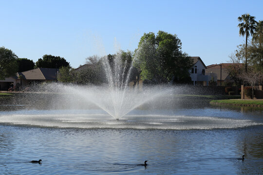 Sparkling droplets in a middle of North lake fountain at Dos Lagos park, Glendale, Arizona