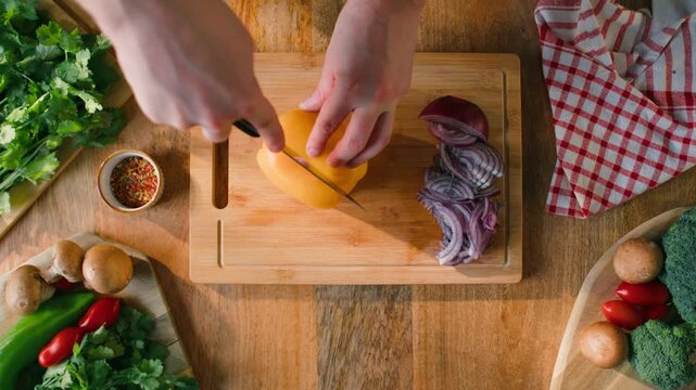 Man cut yellow sweet pepper, Healthy food, Chef hands with knife for onion, cutting and preparation with cooking for dish. Restaurant, culinary service and cook with skills for catering