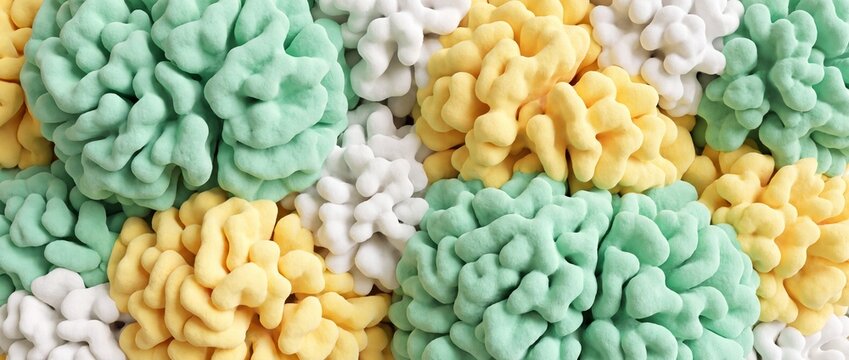 A close-up, macro shot showcases a colorful assortment of pastel-colored puffy snacks, arranged in a delightful pattern that evokes a sense of whimsical fun and satisfying crunch.