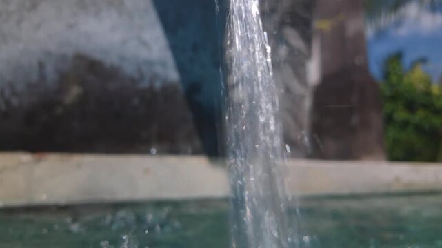 Underwater shot of a swimming pool with bubbles and a water stream pouring from a fountain