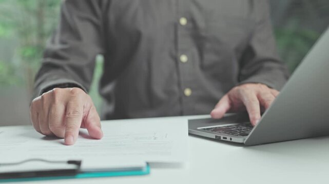 Accountant performs financial analysis on paper records, executing precise data analysis evaluate corporate report figures.