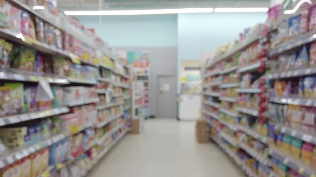 Blurred view walking through a supermarket snack aisle