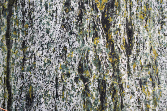 Close-up view of textured stone surface with various colors