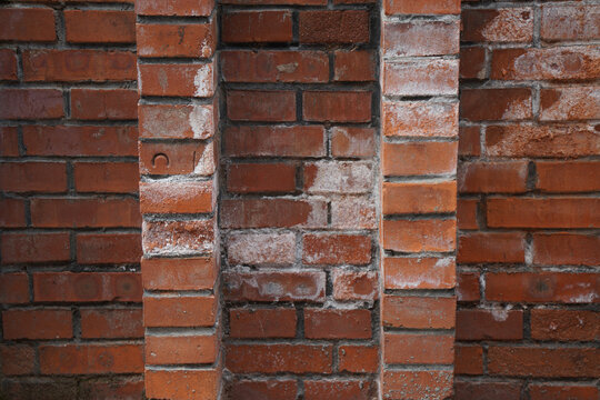 Old brick wall texture with visible cracks and patches