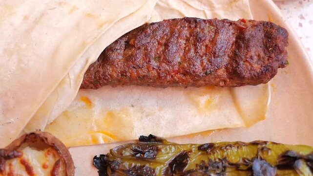 Grilled turkish kebab meat served with roasted pepper on flatbread