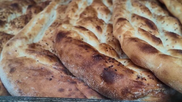 Traditional turkish flatbread pide stacked in a bakery display