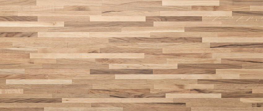 Light oak parquet flooring background featuring staggered brick block pattern with mixed tones ideal for interior design