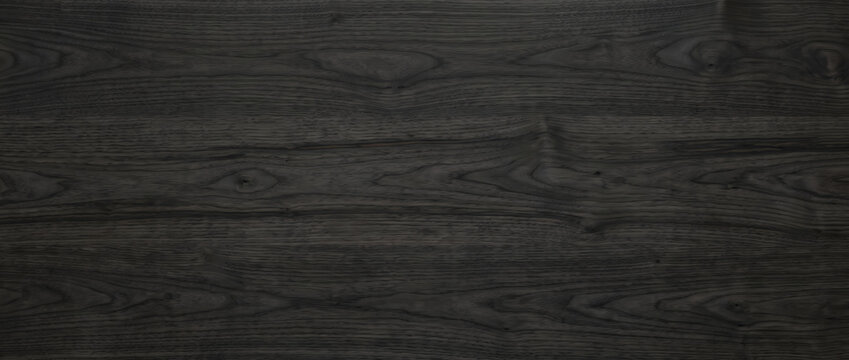 Dark black ebony wood grain texture with subtle cathedral pattern for a moody luxurious furniture background
