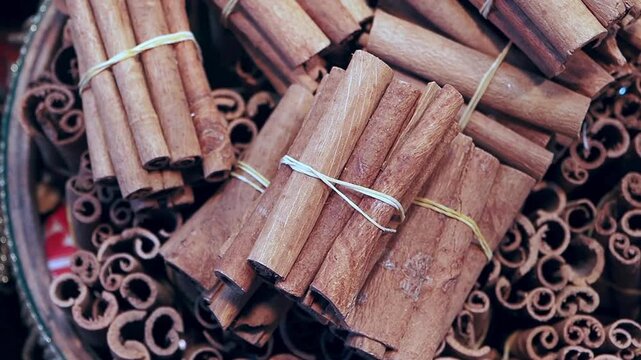 Aromatic cinnamon sticks bundled with string in a rustic bowl