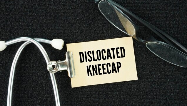 Stethoscope and paper with the word dislocated kneecap happens when the patella slips out of its normal groove on the side of the thigh bone, causing sharp pain, swelling, and a visible deformity.