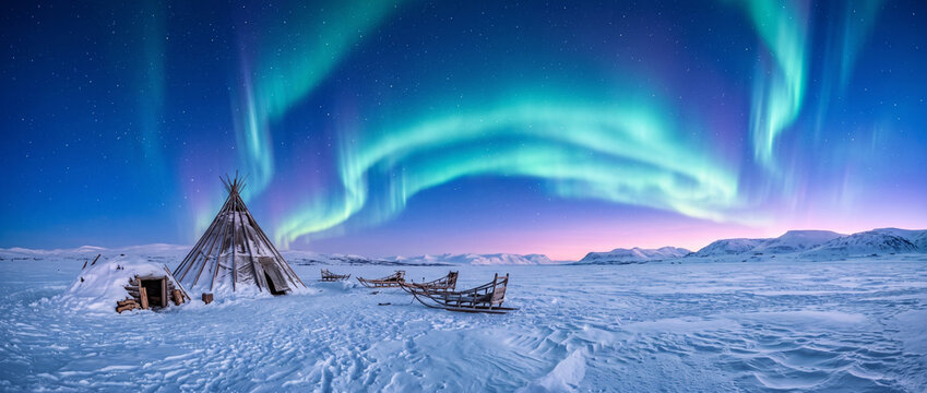Vibrant Northern Lights Over a Snowy Arctic Landscape at Twilight
