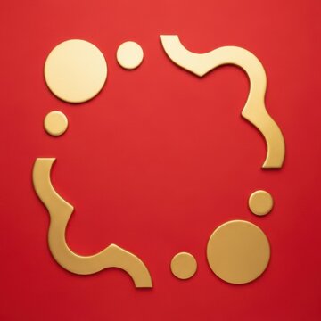 Minimalist top-down view of a red background featuring abstract metallic gold geometric shapes, including various circles and wavy lines arranged to create a central frame.