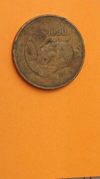 Mexican Thousand Pesos 1988 Vintage Coin on Orange Background