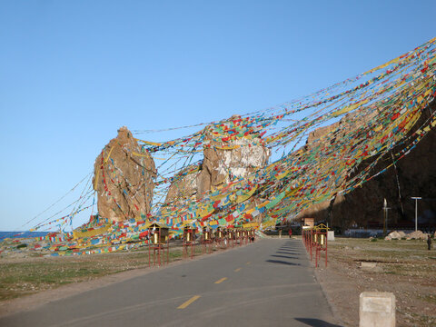 Colorful prayer flags hanging in front of rock formations