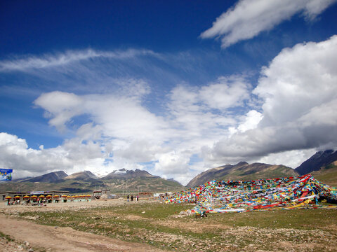 Beautiful mountain landscape with colorful prayer flags under a blue sky
