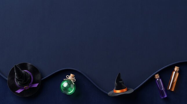 Halloween background featuring miniature black witch hats and glass bottles filled with glowing green, purple, and orange liquids arranged on a dark blue surface