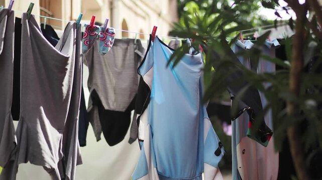 Garments hanging out to dry on a clothesline in a neighborhood setting