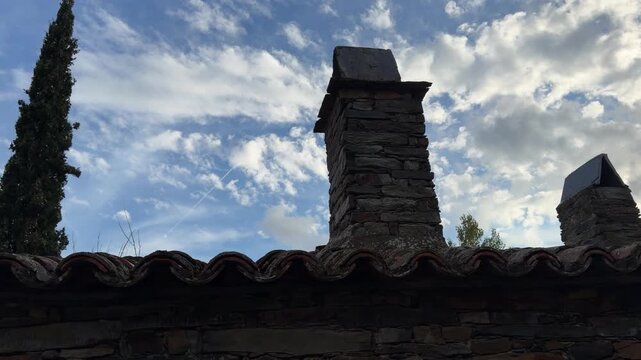 Patones old rustic stone chimney and mossy roof tiles in patones de arriba