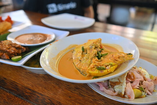 Gulai Kapalo Lauak, is a rich, spicy West Sumatran delicacy featuring a large fish head (typically red snapper or sea fish) simmered in a golden coconut milk broth infused with traditional aromatics