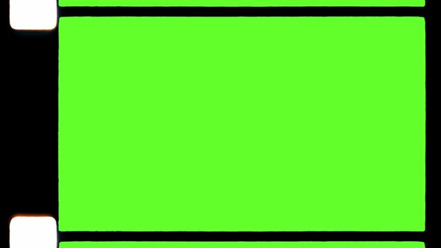 Vintage 35mm film strip rolling with green screen