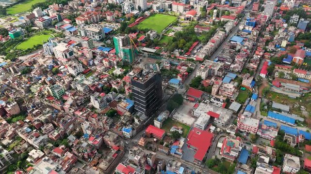 Aerial view of a burnt multistory commercial building in urban Kathmandu.
