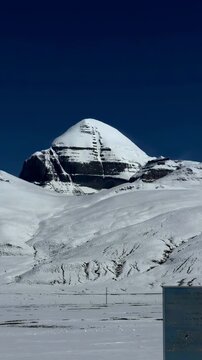 Mount Kailash, also known as Gang Rinpoche, sacred mountain revered in Tibetan Buddhism and Hinduism, rising snow-covered above the remote Ngari landscape of Tibet